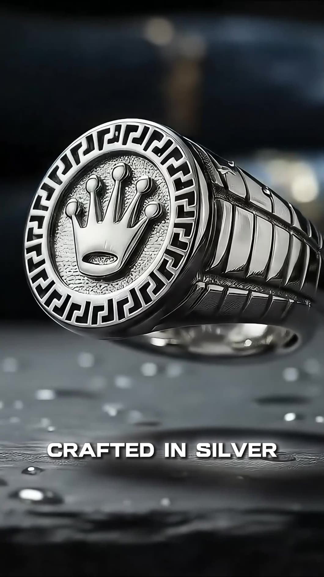 Close-up of the engraved crown and Greek-key border, with the caption “Crafted in silver”