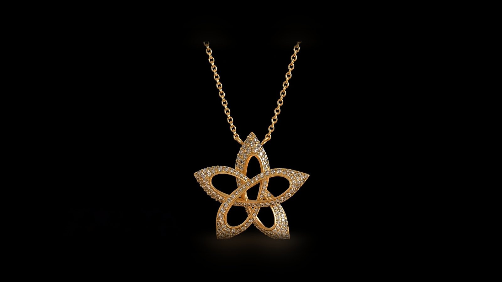 3D gold star pendant with pavé stones, hanging from a fine chain